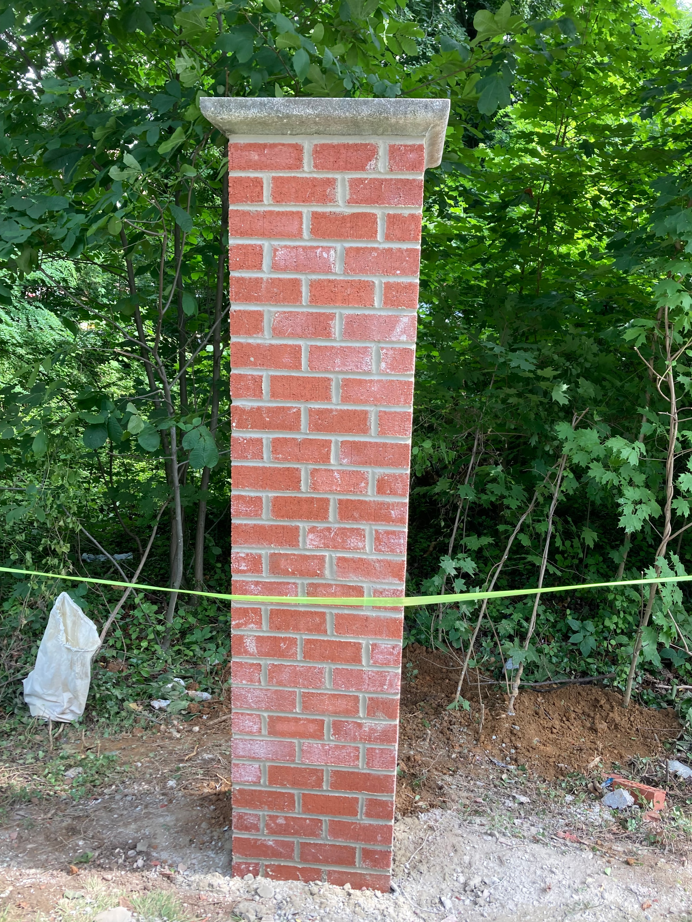 New red brick masonry pillar with concrete cap