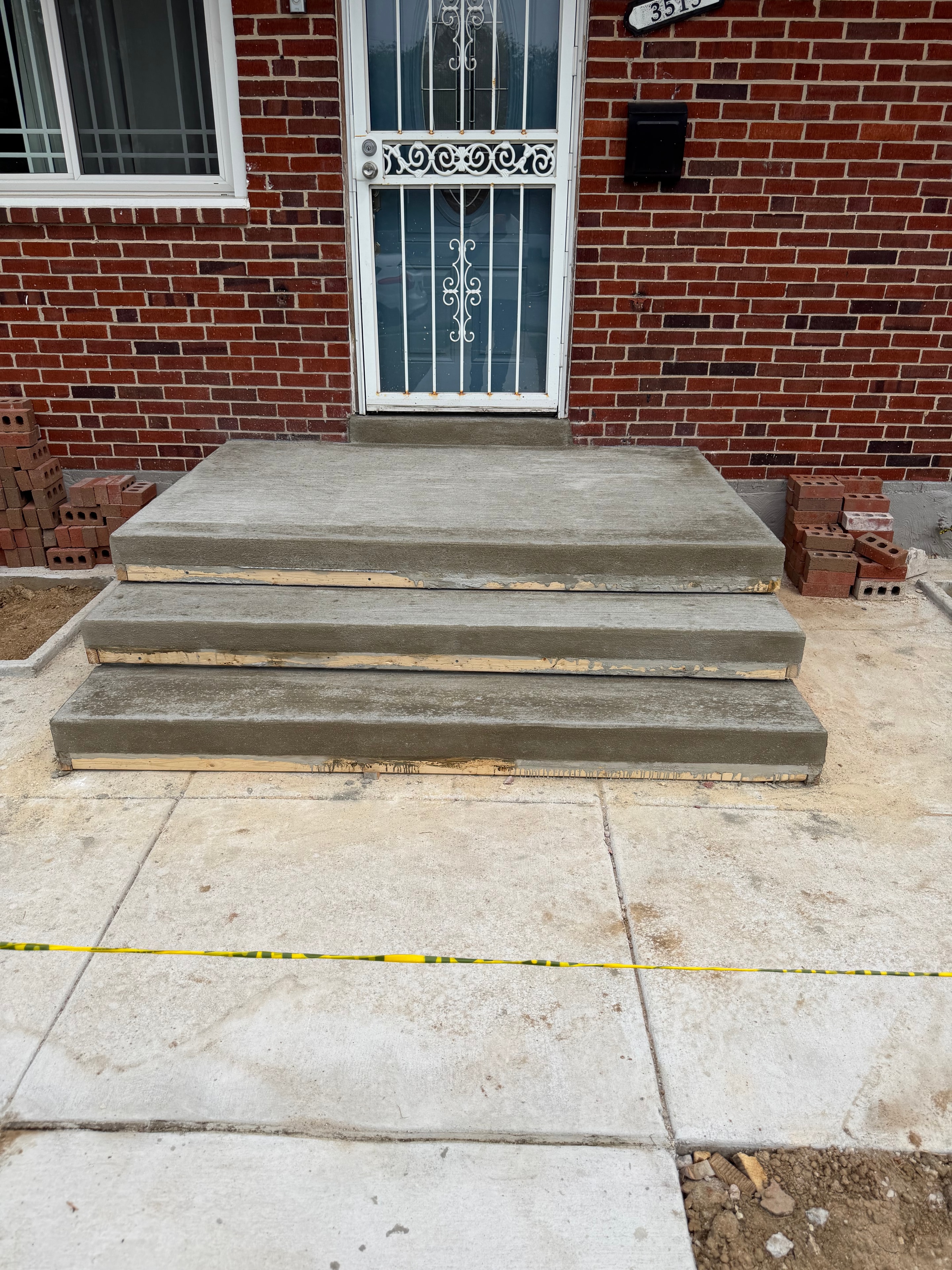 New concrete steps at a brick home entrance