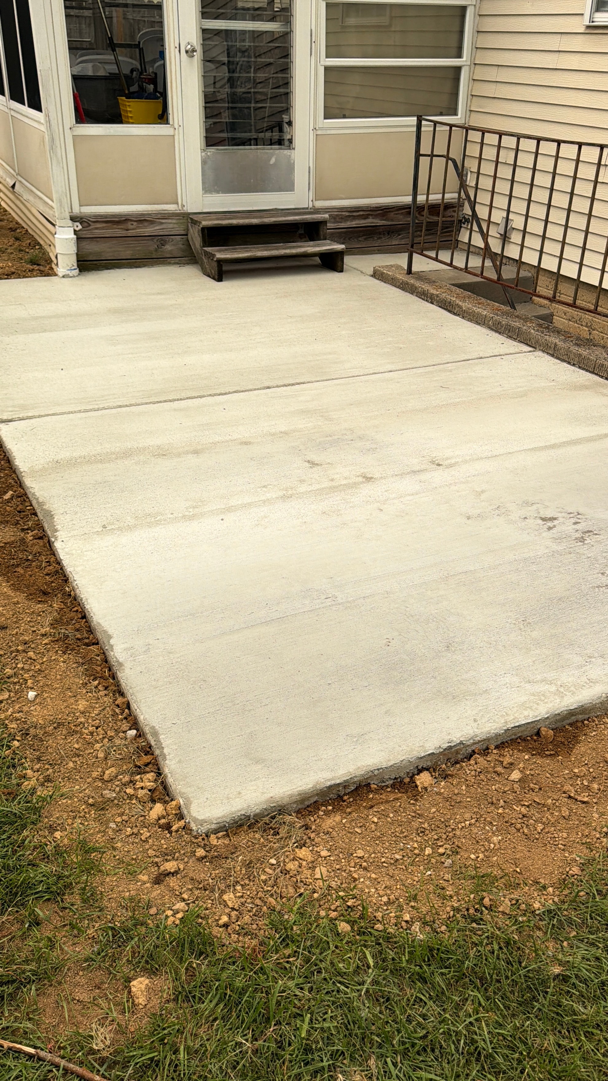 Finished concrete walkway and entrance pad at a residential home
