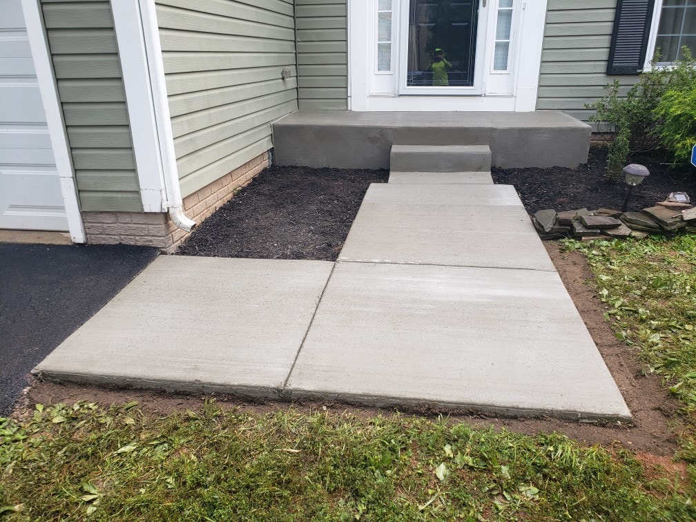 New concrete walkway and entry steps at a residential home