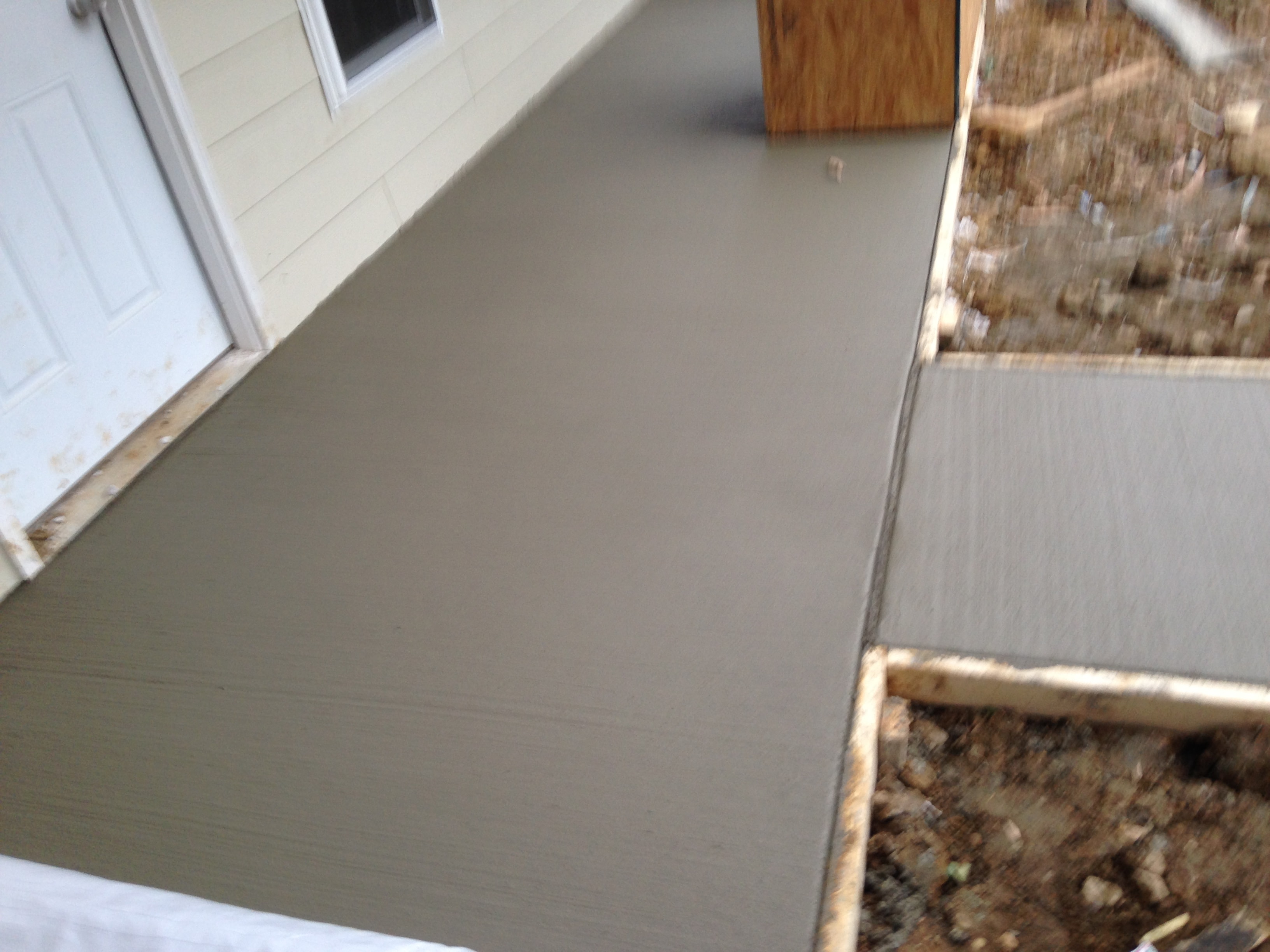 Fresh concrete porch and walkway pour at a residential home